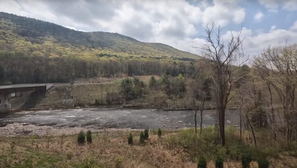 a beautiful landscape with a river and a bridge in Jim Thorpe, Pennsylvania