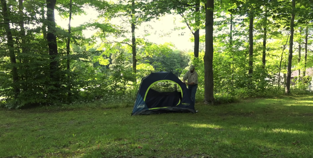 Man pitching a tent in Blue Knob, Pennsylvania.